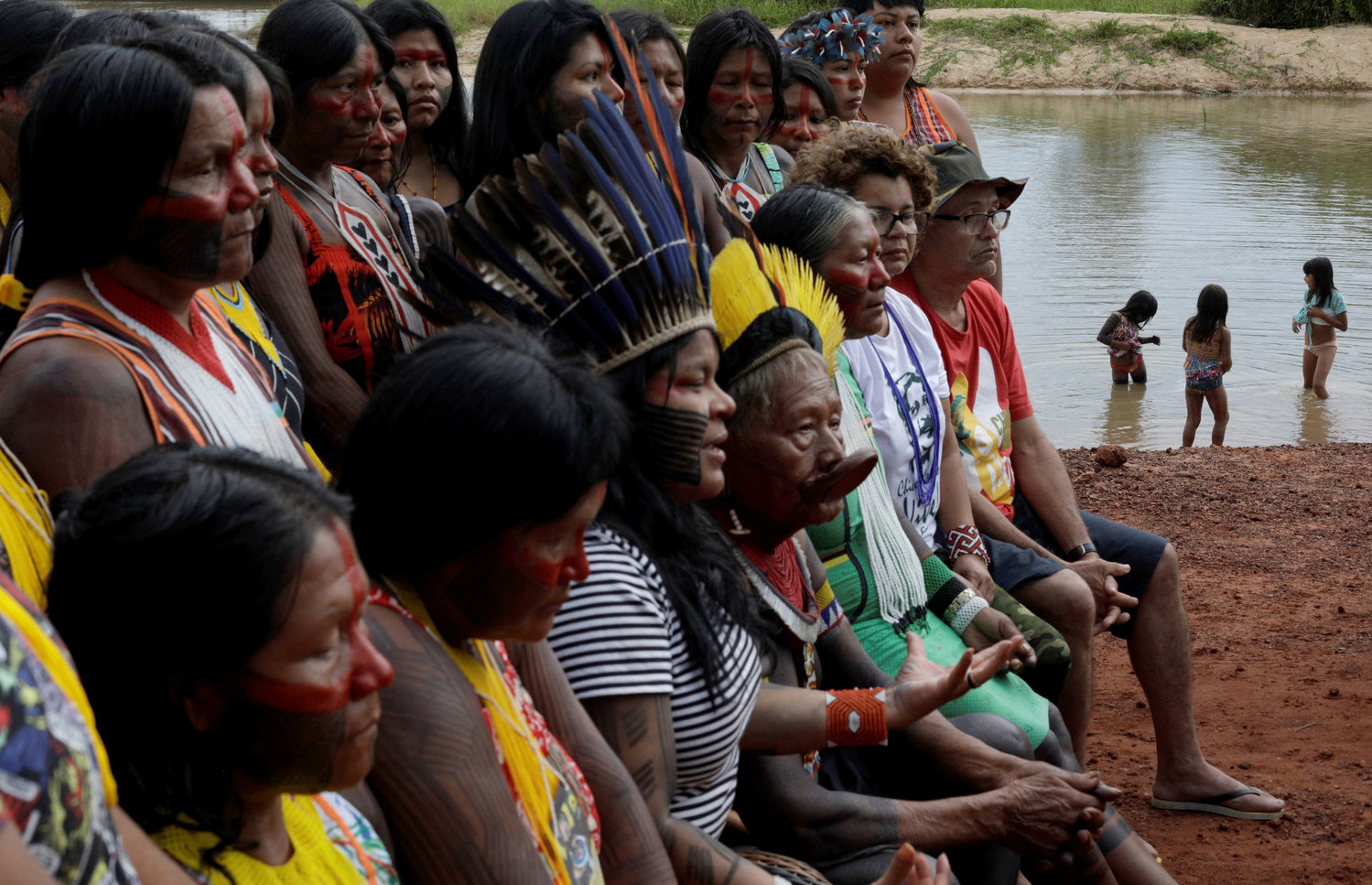 Indigenous people are seen on the banks of the Xingu River during a media event in Brazil’s Xingu Indigenous Park Jan. 15, 2020.